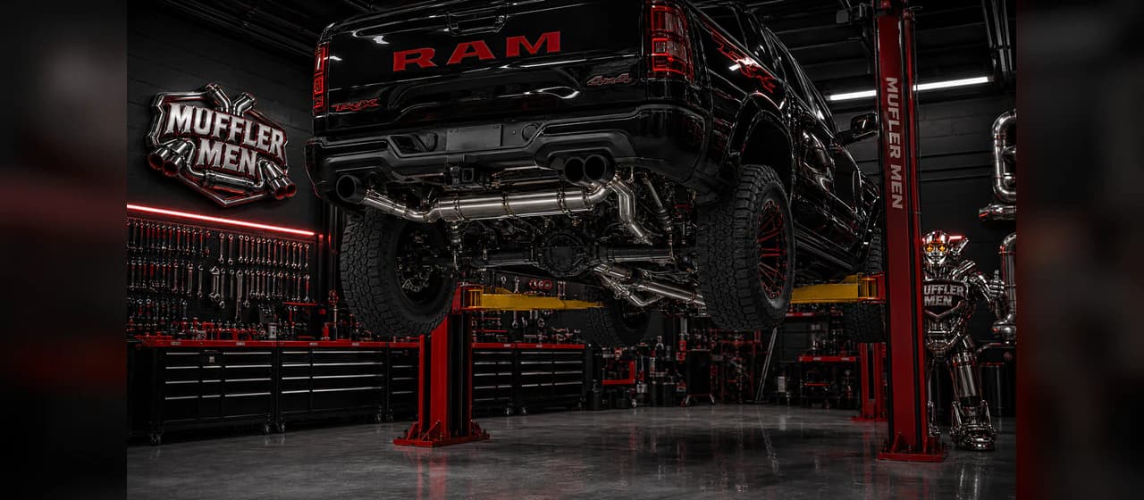 Custom exhaust systems | Oak Flats Muffler Men 2021 Dodge RAM 1500 TRX custom exhaust routing on the Muffler Men workshop hoist